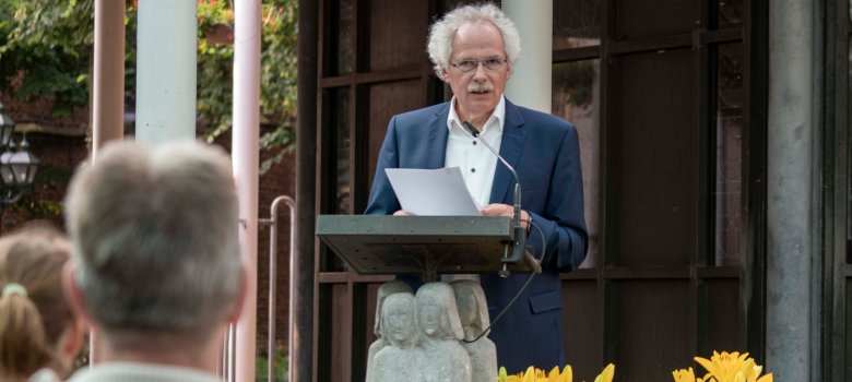 A speaker stands at the lectern.