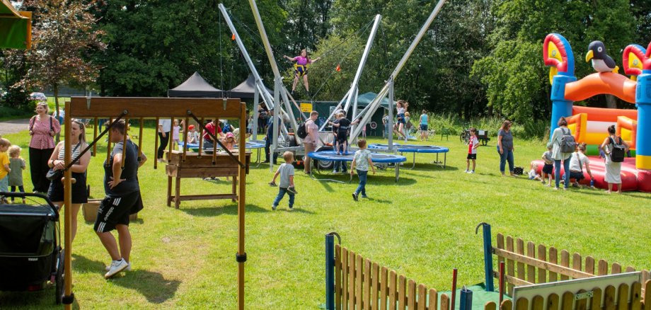 Children playing on bouncy castles and trampolines