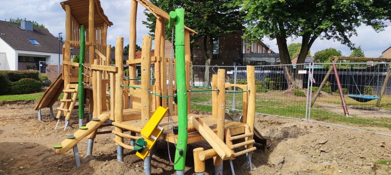 A large wooden climbing frame, the foundations of which can still be seen.