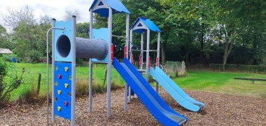 A large blue climbing frame on a playground.